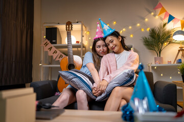 Two Asian women in room with Ciematic lighting celebrate important events such birthdays Christmas