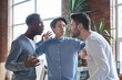 © Prostock-studio - Office conflict concept. Young angry multiracial men fighting at office
