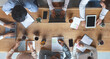 © Prostock-studio - Office lifestyle. International young business team having morning briefing at office, top view