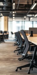 Poster - A large office with many black chairs and a black desk. The chairs are arranged in rows and the desk is empty. The room is very clean and organized