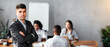 © Prostock-studio - Business Leadership. Serious Businessman Standing Crossing Hands In Front Of His Business Team In Modern Office.