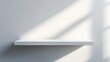 © Giovanni - Minimalist background for product display featuring a white shelf against a soft gray wall