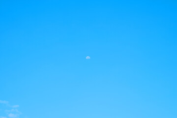 Wall Mural - beautiful blue clouds and a distant moon. for the background.