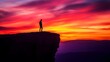 © Berkah - Man standing on top of cliff at sunset.