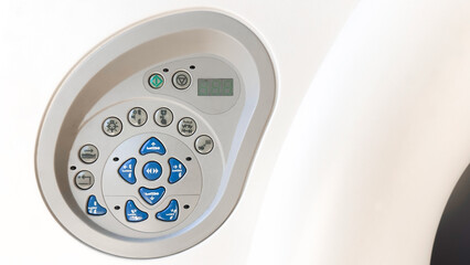 A close-up of a medical device control panel with various buttons and display screen, designed for operational functionality in a clinical setting.

