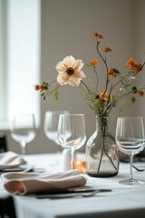 Minimal Thanksgiving table setup with a single flower in a vase as the centerpiece.