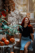 Portrait of young woman with red hair on stone staircase