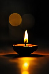 A close-up of a single candle flame in a dark setting, casting a warm glow and reflecting on a smooth surface.