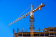 © licvin - construction cranes are building a house