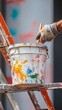 © liliyabatyrova - A person is painting a bucket with a brush