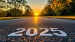 © Koh's Smart - High definition stock photo of the word '2025' written on a smooth asphalt road at sunset, symbolizing new beginnings and setting goals for the upcoming year.