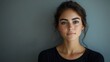 © The Little Hut - Beautiful woman with long brown hair and captivating eyes in black shirt looking directly at camera against gray background : Generative AI