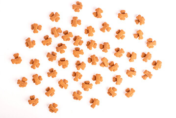 Top view of crunchy brown bone shaped dog biscuit as a treat set isolated on white background close up