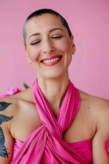 A woman with a pink dress and a blue tattoo on her arm is smiling