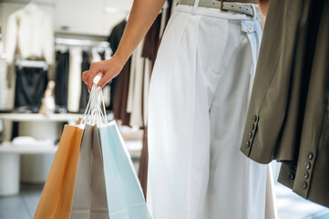 Close up view of woman that is chooses clothes in the retail shop