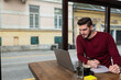 © Srdjan - One young businessman sitting in cafeteria taking a coffee break while working online on laptop computer. Business male professional occupation e-commerce and remotely finance and economy research