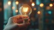 © ceoJAHID - A hand holding a light bulb