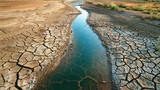 Lake and rugged desolate texture that captures the essence of arid landscapes and the harshness of drought conditions. Cracked dry earth