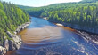 © bcendet - A river with a clear and a muddy section separated by a sand bar, with green forest on each side.