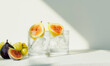 © Vlad - Refreshing Fig-Infused Drinks with Grapes and Ice in Sunlit Setting