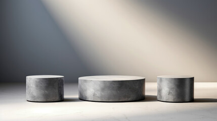 Poster - This image features three cylindrical concrete pedestals of varying heights under a focused spotlight, emphasizing their simplicity and industrial aesthetic appeal.
