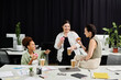 © Bliss - A lively discussion unfolds as businesswomen share donuts and coffee, exchanging ideas in an office.