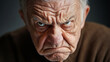 © ABX - Angry elderly man with intense gaze and stern face