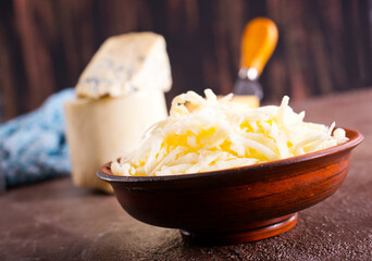 Wall Mural - grated cheese in bowl, mix from cheese