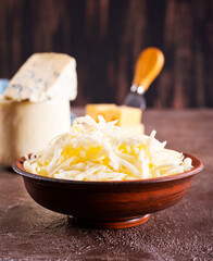 Wall Mural - grated cheese in bowl, mix from cheese