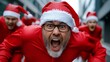© Nataliia_Trushchenko - Man in a red Santa hat is yelling and has his mouth open. He is surrounded by other people in red costumes