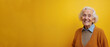 © Yury - Elderly woman with cheerful smile posing against bright yellow background with copy space