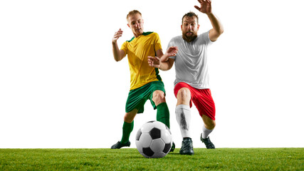 Wall Mural - Two soccer players' legs as they battle for ball on green soccer stadium against white studio background, with focus on tension and athletic footwear. Concept of sport event, motion, championship. Ad