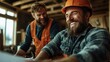 © JoxyAimages - Two cheerful construction workers wearing safety gear share a laugh on a construction site, emphasizing friendship and teamwork in a professional setting.