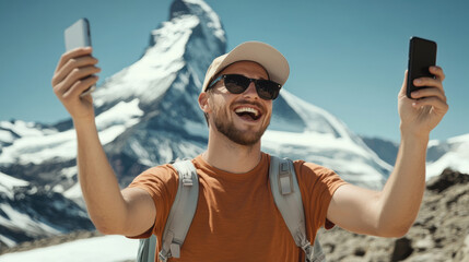 Wall Mural - A man is smiling and holding two cell phones, one of which is a black one