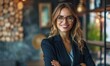 © Onchira - Portrait of happy smiling confident businesswoman wearing eyeglasses, standing with arms crossed. Copy space, corporate female manager, success at company work or job, CEO girl career
