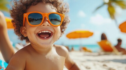 Wall Mural - A smiling child wearing orange sunglasses exudes happiness in a lively beach setting, with other beachgoers and bright umbrellas providing vibrant summer energy.