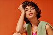 © LIGHTFIELD STUDIOS - The young woman gazes thoughtfully, showcasing her expressive emotions with a colorful backdrop.