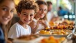 © Chatchanan - Children enjoying a hotel breakfast buffet, with their parents happily sitting