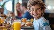 © Chatchanan - Children enjoying a hotel breakfast buffet, with their parents happily sitting