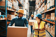 © Davor - Warehouse workers in hard hats checking inventory and lifting boxes