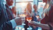 © Justlight - A defocused scene of networking with the clinking of glasses and the rustle of business attire.