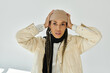 © Bliss - Beautiful african american woman in autumn stylish attire on white backdrop.