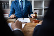 © Wasan - Lawyer is giving legal advice to a businessman in the legal counsel's office. Meeting with the legal team to discuss the agreement together.