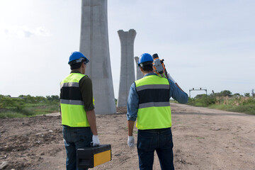 Surveyors working at new construction site. construction worker on a site. Surveyor engineers using an Leveling camera at Construction Site.