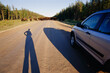 © Designpics - Shadow of a traveler by their vehicle waiting for a herd of buffalo (Bison bison) to move off the road in Wood Buffalo National Park, Northwest Territories, Canada; Northwest Territories, Canada
