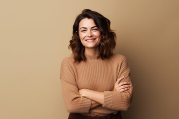 Sticker - Portrait of a satisfied woman in her 30s wearing a cozy sweater over blank studio backdrop