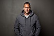 © Markus Schröder - Portrait of a blissful man in his 40s wearing a zip-up fleece hoodie in plain cyclorama studio wall
