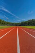 © Sea Lily - Empty red running track with white lines on the ground, outdoor sports complex.