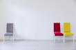 © dmitriisimakov - many chairs of different colors in the interior of an empty white office room