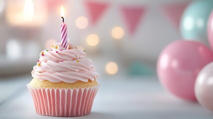 Wall Mural - A pink frosted cupcake with a lit candle stands out against a festive background of balloons